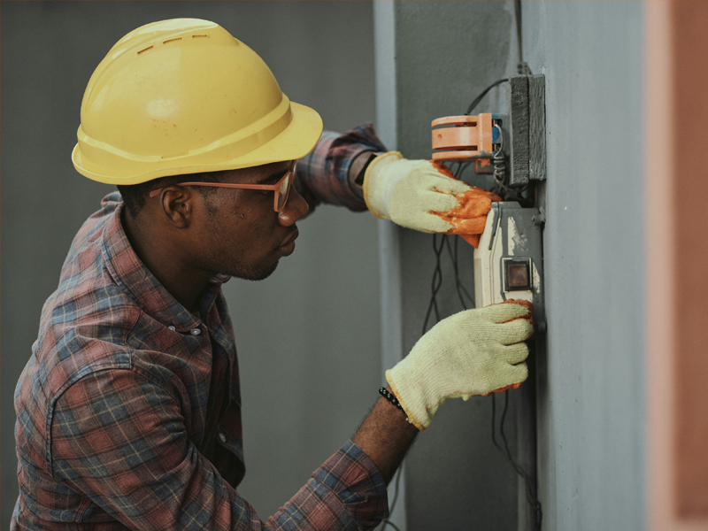 electrician installs wall switch