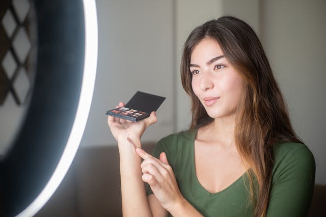beauty influencer showcasing makeup palette