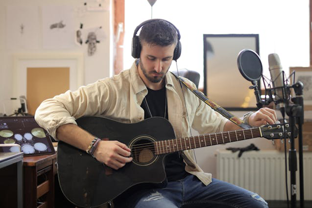 musician records guitar at home